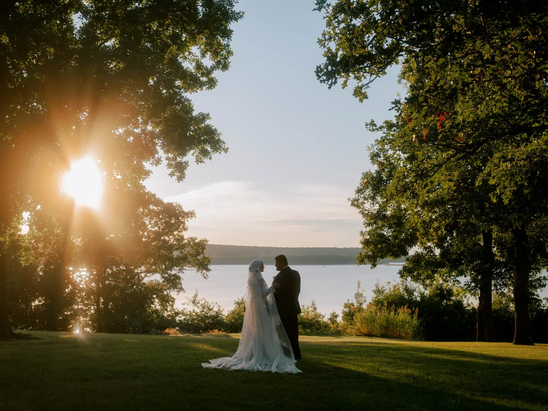 Bride and groom at golden hour by the lake